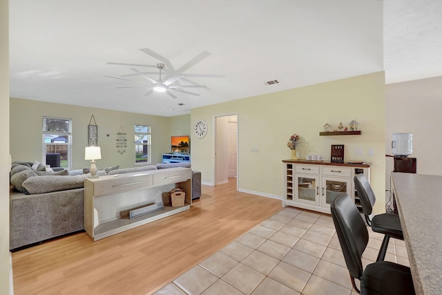 living room featuring ceiling fan and light wood-type flooring