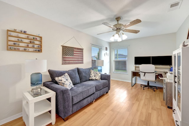 living room with hardwood / wood-style flooring and ceiling fan