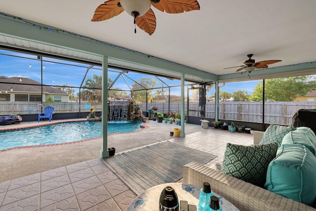 view of pool featuring ceiling fan, a lanai, an outdoor living space, pool water feature, and a patio