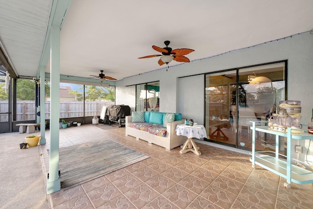 sunroom featuring ceiling fan