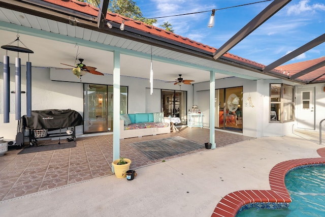 view of patio featuring glass enclosure and a grill