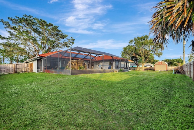 view of yard featuring glass enclosure and a storage shed