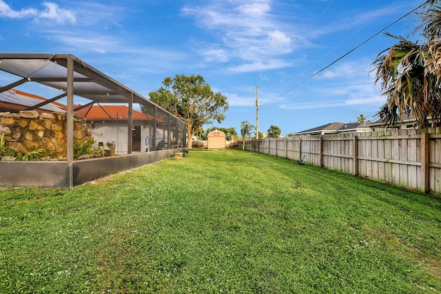 view of yard featuring a storage shed and a lanai