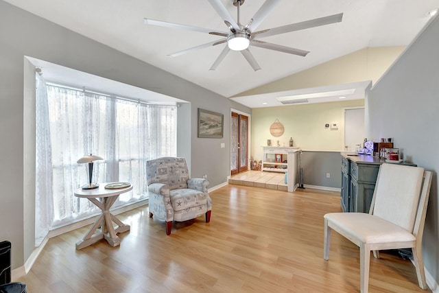 sitting room featuring ceiling fan, light wood-type flooring, and vaulted ceiling