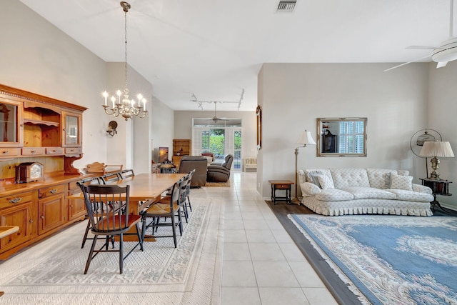 tiled dining room with ceiling fan with notable chandelier