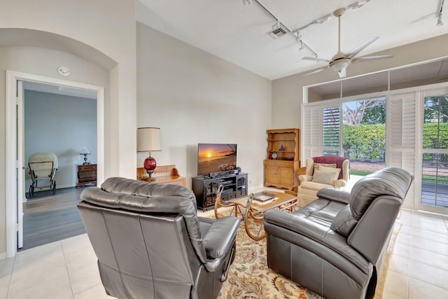 tiled living room featuring rail lighting and ceiling fan