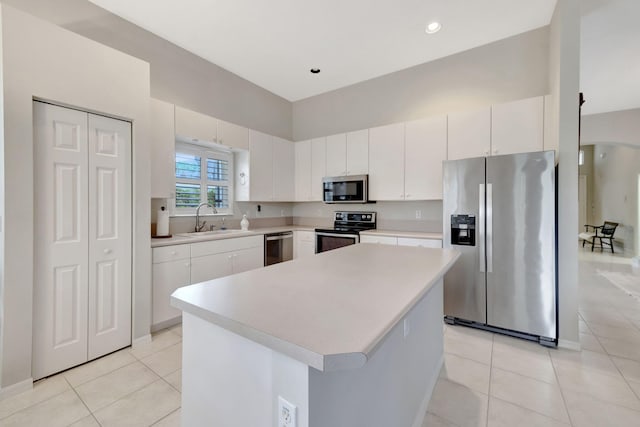 kitchen featuring sink, a center island, white cabinets, and appliances with stainless steel finishes