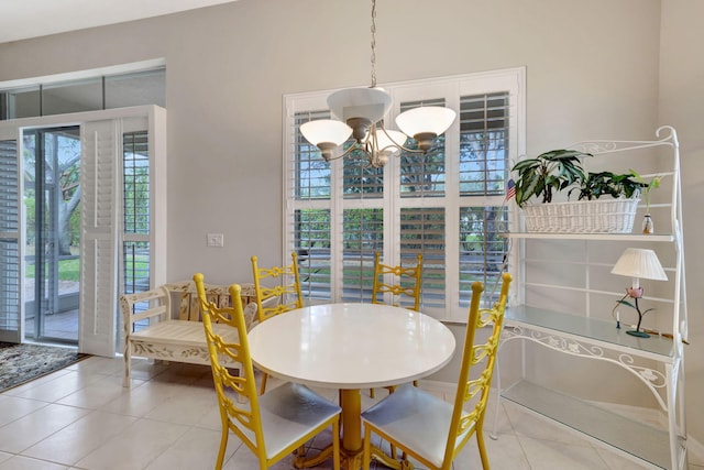 dining space featuring a chandelier and tile patterned floors