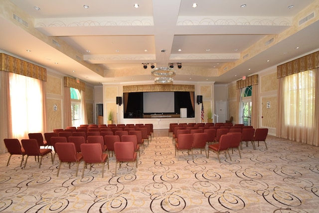 home theater room with beam ceiling, plenty of natural light, and coffered ceiling