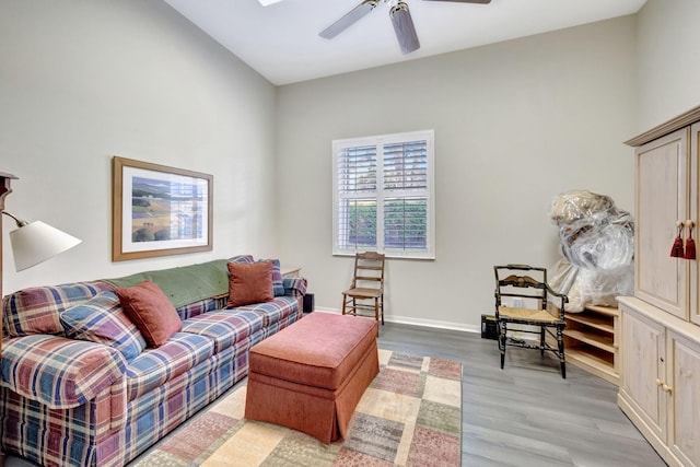 living room with light hardwood / wood-style flooring and ceiling fan