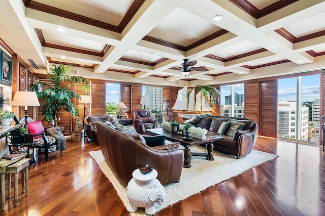 living room featuring ceiling fan, a healthy amount of sunlight, coffered ceiling, and ornamental molding