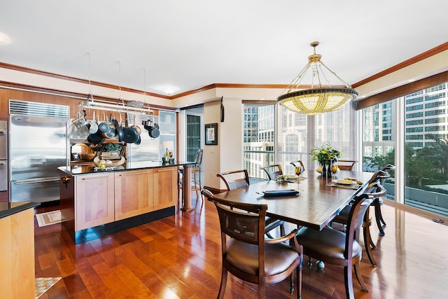 dining space with dark hardwood / wood-style floors and crown molding