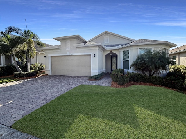 view of front of property with a garage and a front yard