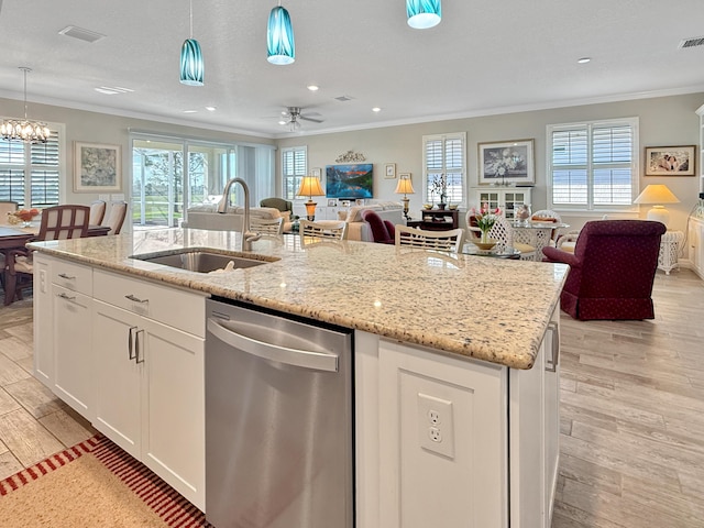 kitchen featuring white cabinetry, sink, hanging light fixtures, a kitchen island with sink, and stainless steel dishwasher