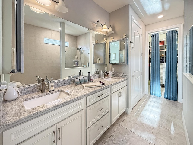 bathroom with vanity and tiled shower