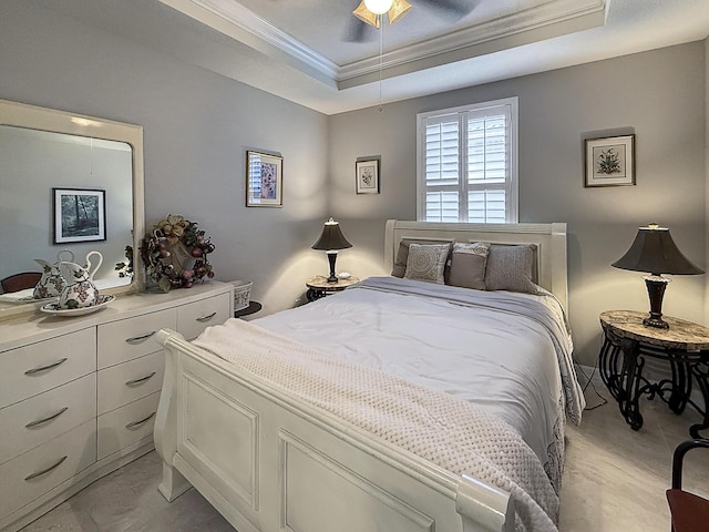 bedroom with ceiling fan, ornamental molding, and a raised ceiling