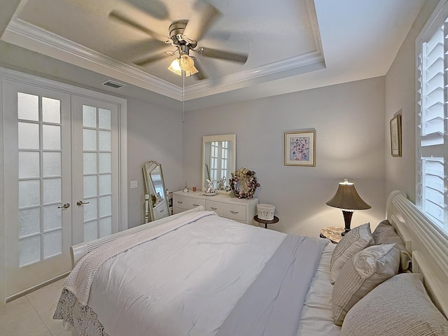 tiled bedroom featuring crown molding, a raised ceiling, ceiling fan, and french doors