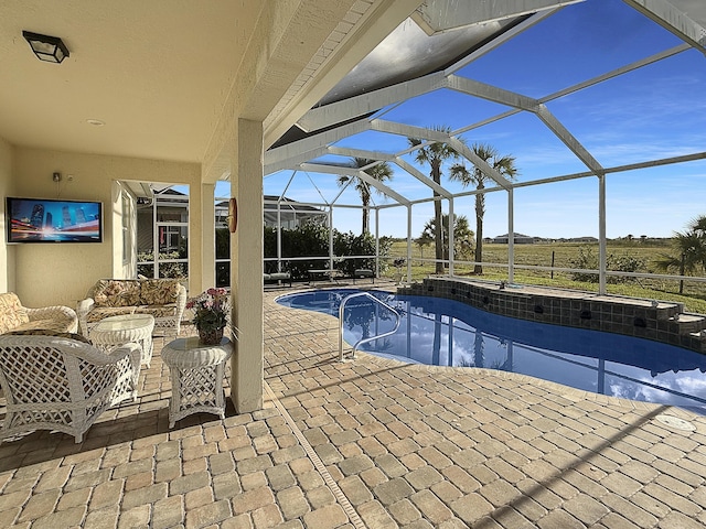 view of swimming pool featuring an outdoor living space, glass enclosure, and a patio area