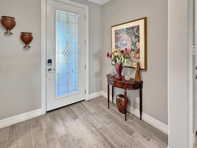 12880 SW Aureolian Ln, Port Saint Lucie, FL 34987 - foyer entrance featuring baseboards, ornamental molding, and wood finished floors