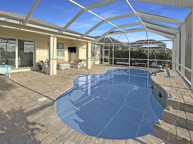 view of swimming pool featuring a patio, a lanai, and an outdoor hangout area