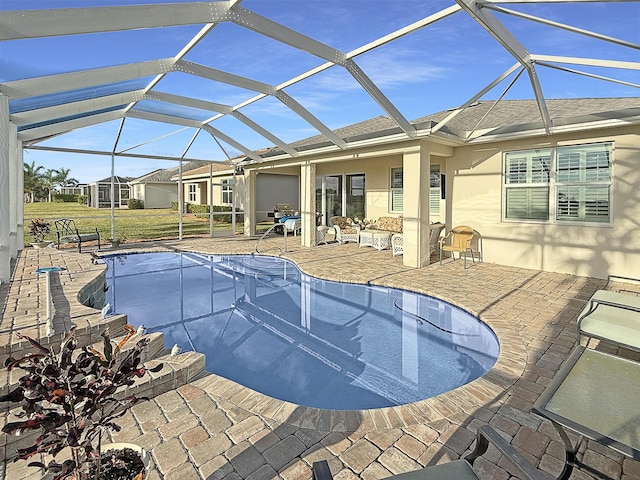 view of pool featuring a patio and glass enclosure