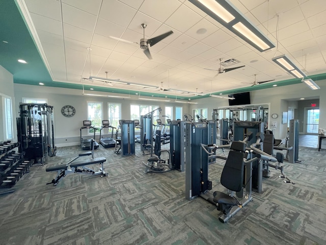 exercise room with ceiling fan and carpet flooring