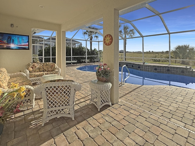 view of patio featuring outdoor lounge area and glass enclosure