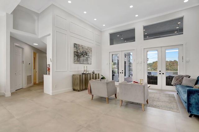 living room featuring ornamental molding, a high ceiling, and french doors