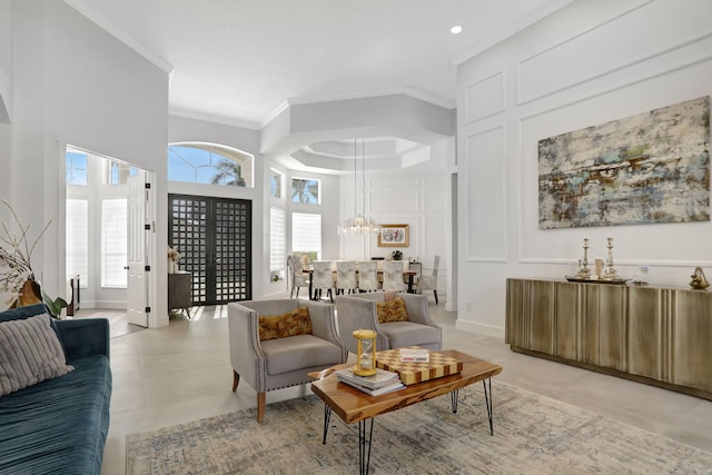 tiled living room featuring crown molding and a notable chandelier