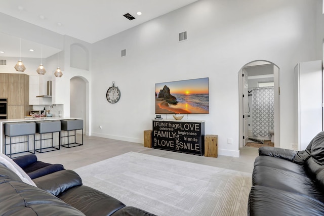 living room featuring a towering ceiling