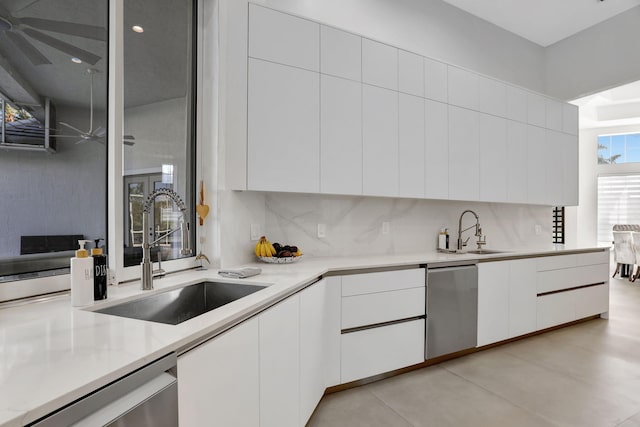 kitchen featuring white cabinetry, dishwasher, and sink