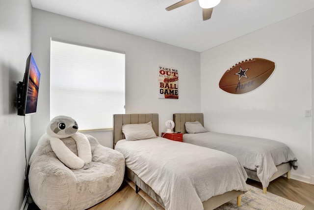 bedroom with ceiling fan and hardwood / wood-style flooring