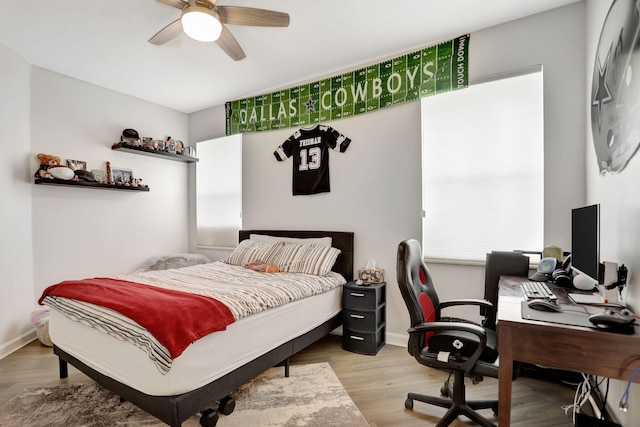 bedroom with light wood-type flooring and ceiling fan