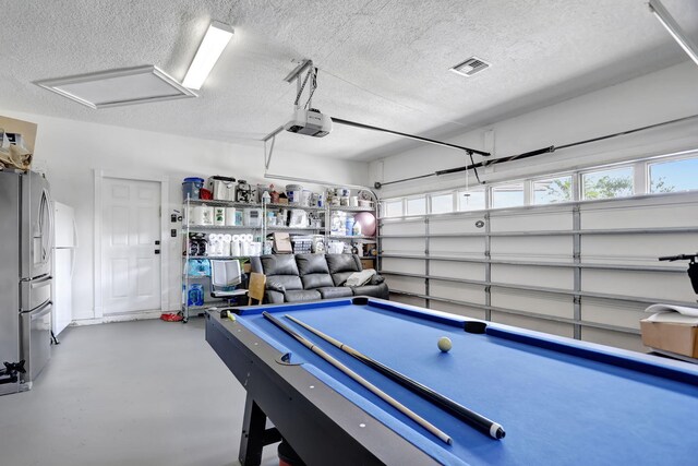 playroom featuring concrete flooring, a textured ceiling, and billiards