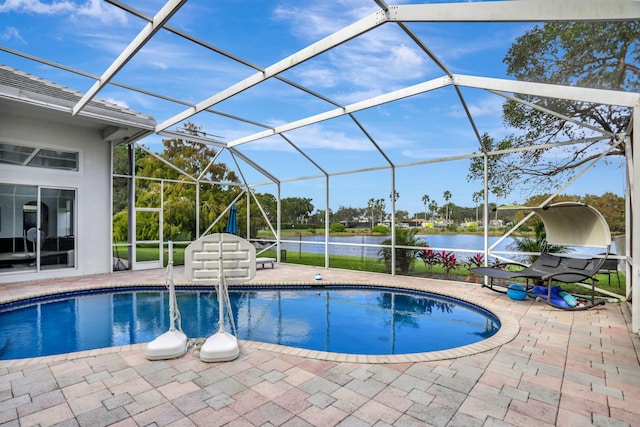 view of pool with a lanai, a water view, and a patio