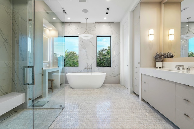 bathroom featuring tile patterned floors, vanity, tile walls, and shower with separate bathtub