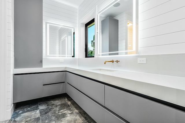 bathroom with vanity and wooden walls