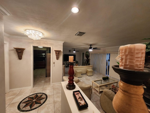 tiled living room featuring ceiling fan with notable chandelier and ornamental molding