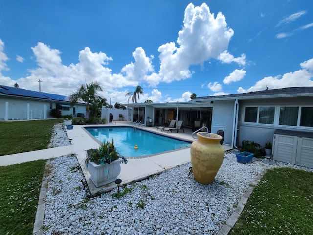 view of swimming pool featuring a yard and a patio