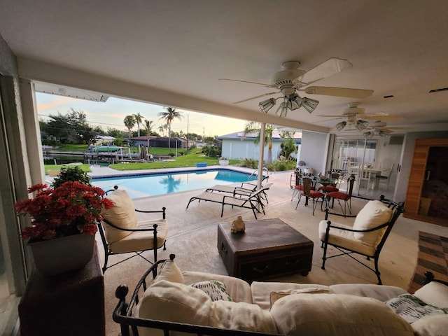 pool at dusk featuring a patio