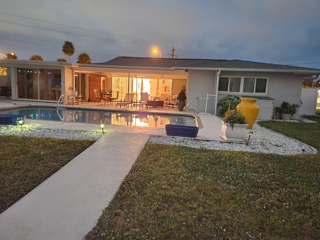 rear view of house with a lawn and a patio area