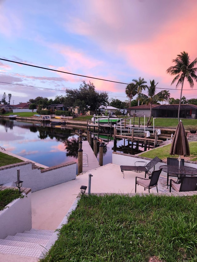 view of home's community with a boat dock and a water view