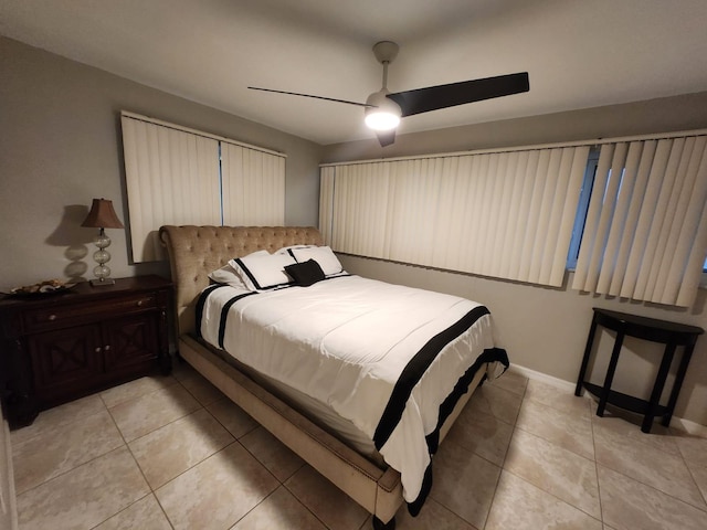 bedroom with ceiling fan and light tile patterned flooring