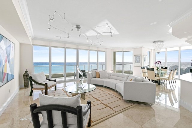 living room featuring a chandelier, a water view, floor to ceiling windows, and ornamental molding