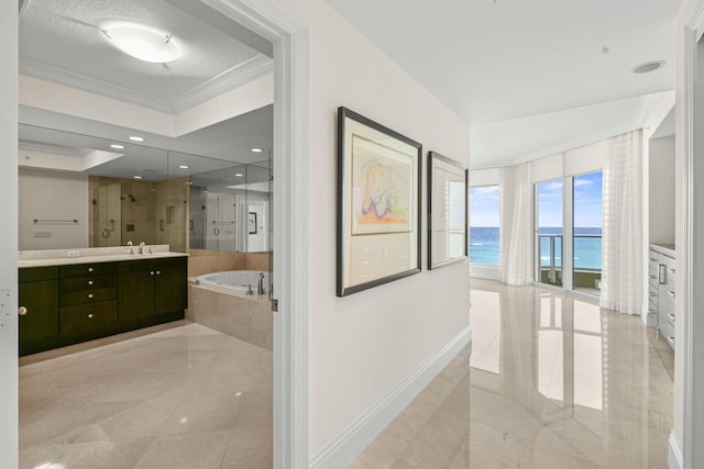 bathroom with vanity, plus walk in shower, a water view, ornamental molding, and a textured ceiling