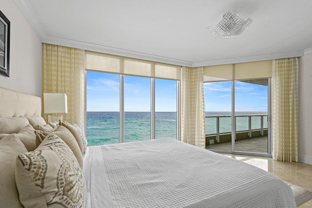 bedroom with multiple windows, access to outside, a water view, and a wall of windows