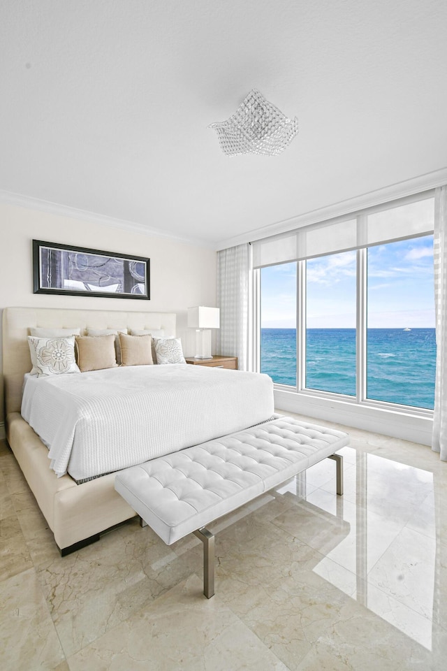 bedroom with a water view and crown molding