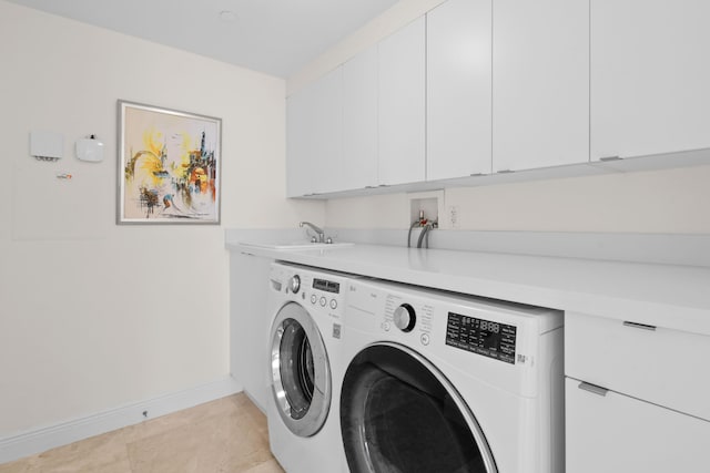 laundry room with cabinets, light tile patterned flooring, washer and dryer, and sink