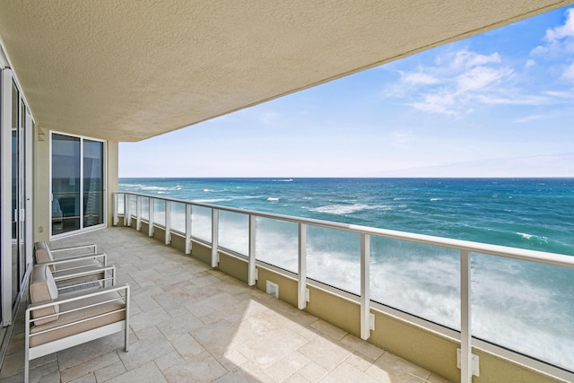 balcony with a view of the beach and a water view