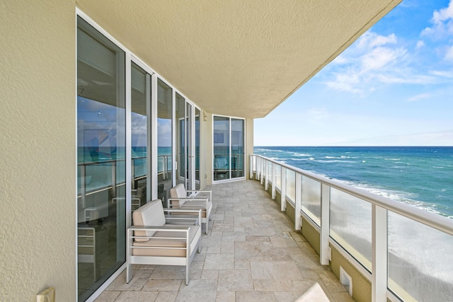 balcony with a view of the beach and a water view